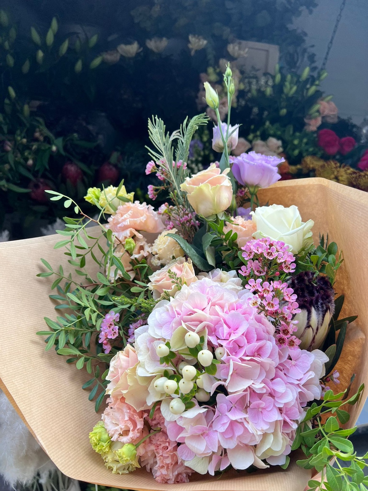 Deep red roses arranged in a clear glass vase